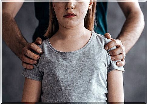 Father with hands on his daughter's shoulders