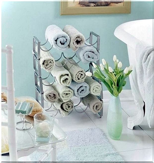 Using a wine rack to accommodate towels can help you have a clean and organized bathroom.