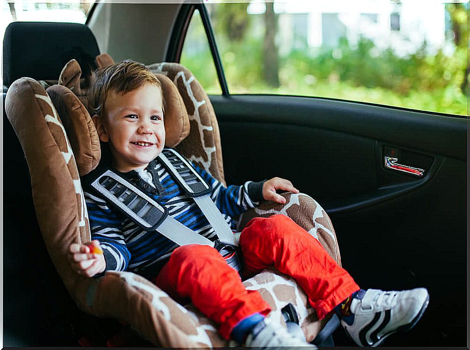 Little boy in car.