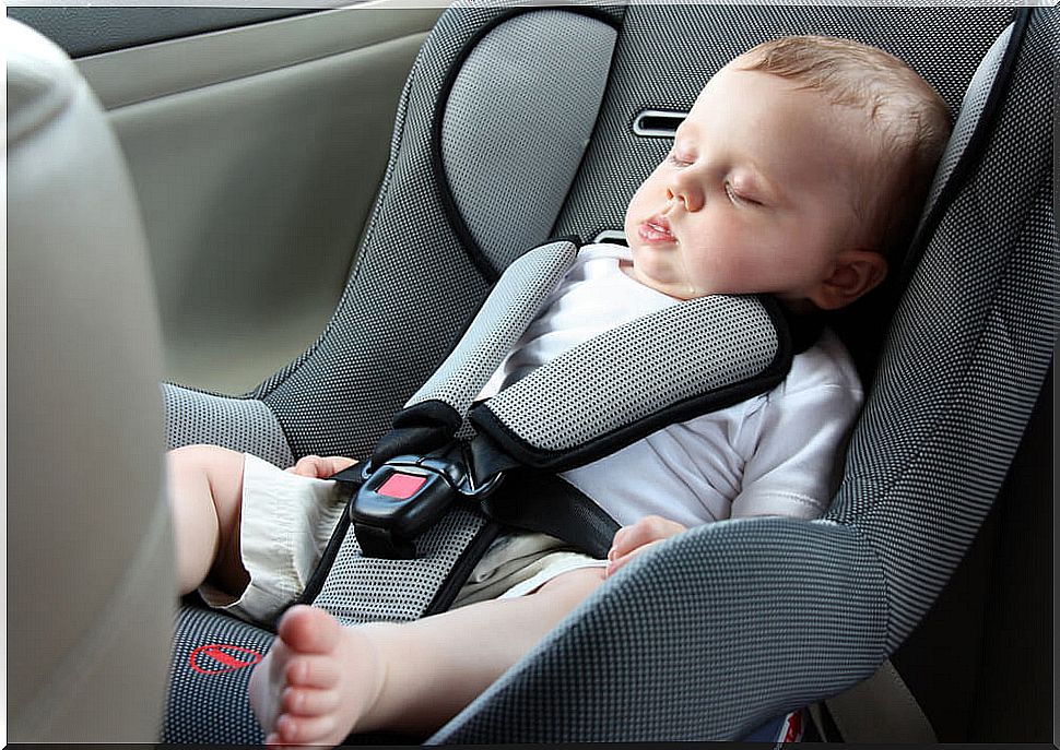 Child sleeping in the car seat.