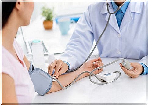 Woman taking blood pressure