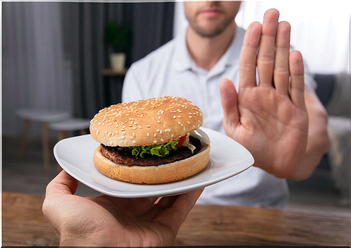 Man rejects food that causes heartburn.