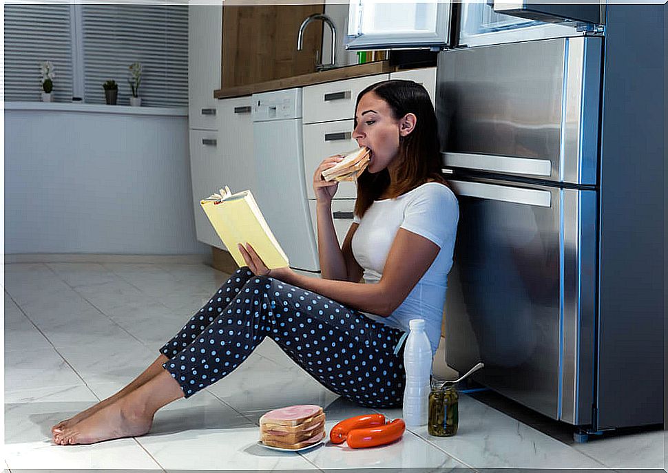 Woman eating on kitchen floor