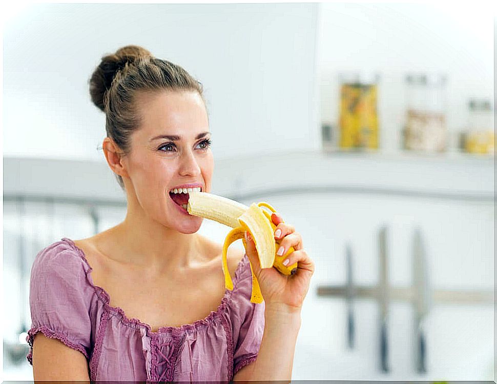 Woman eating banana